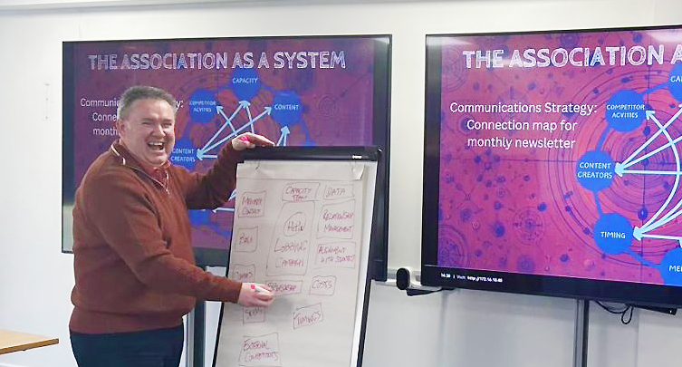 Andrew Chamberlain teaching a workshop on business.