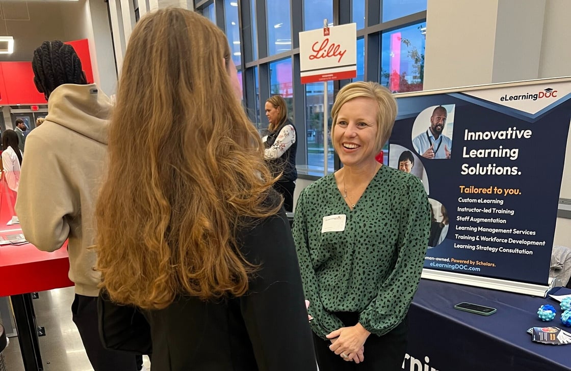 Dr. Angela Robbins speaking to college student at the career fair.