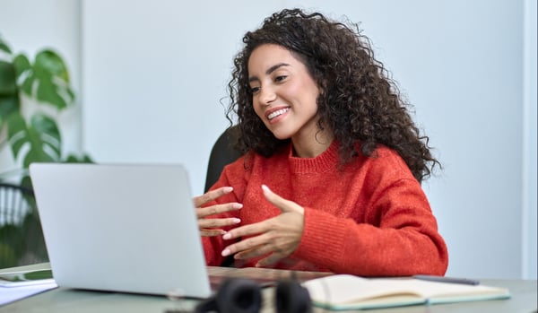 Woman engaged in a webinar on her laptop.
