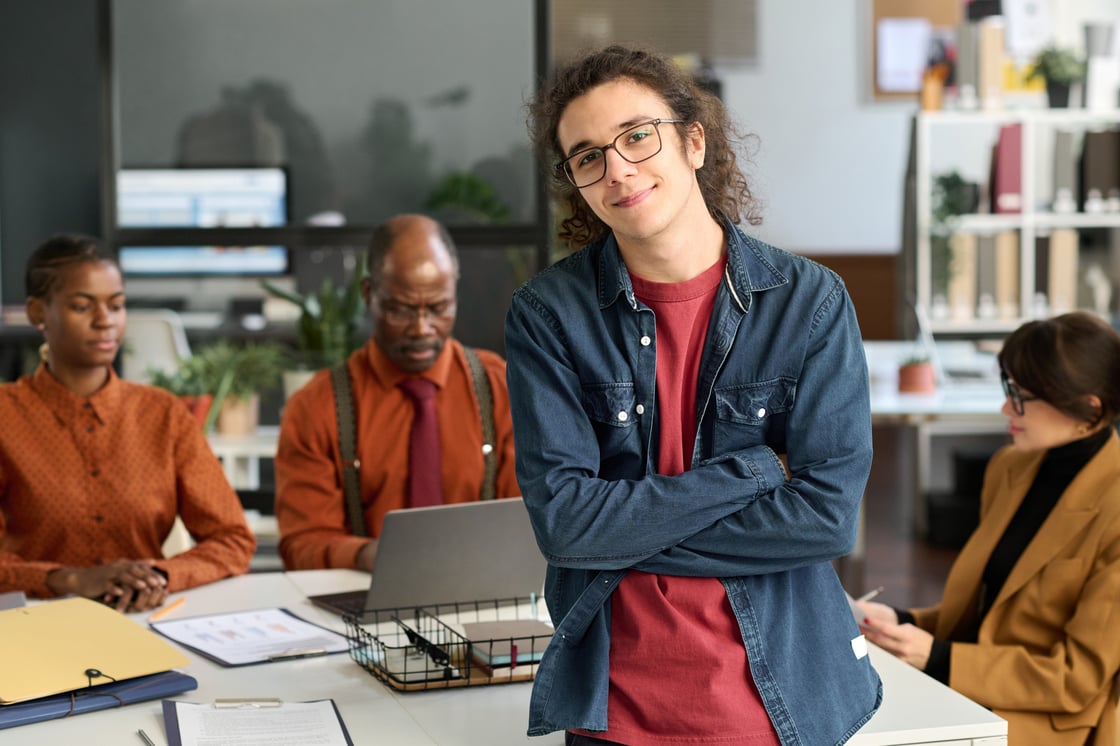Twenty something employees working at office table.