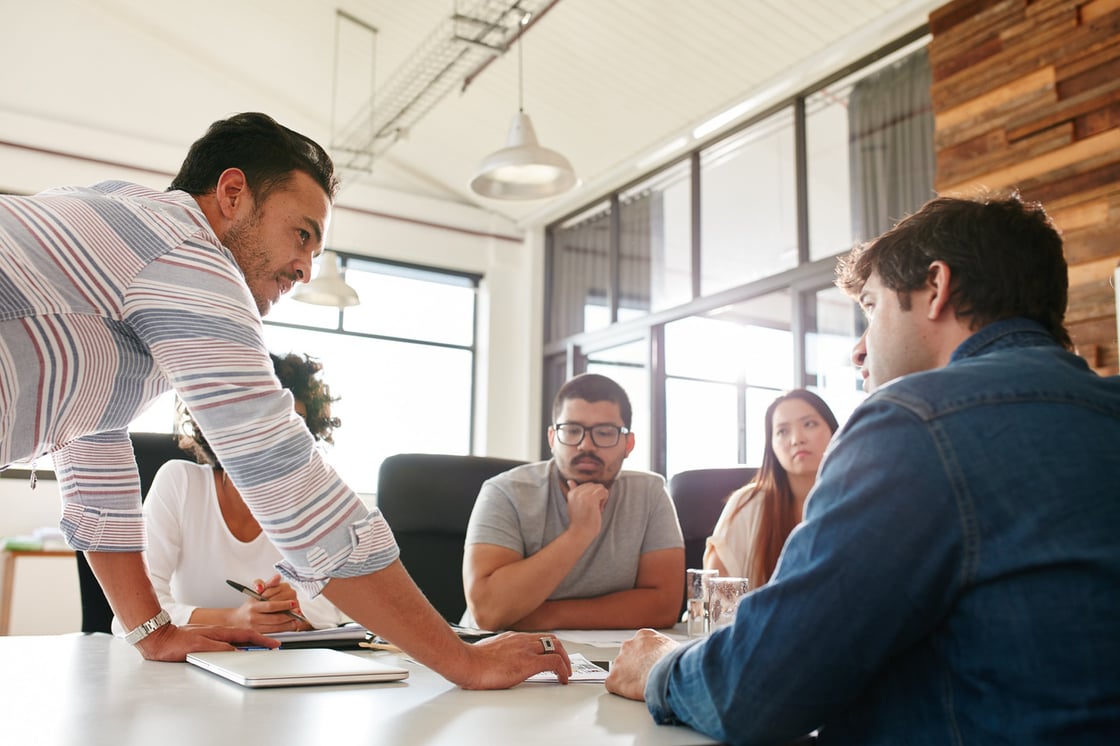 Group of business people around a conference table.